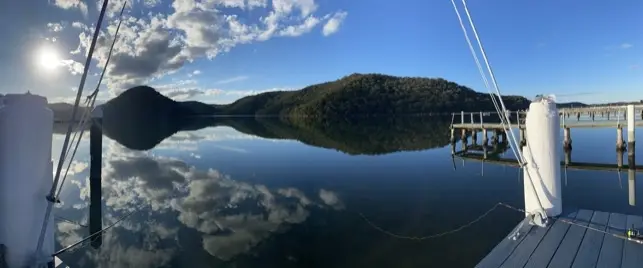 Open view across still water and surrounding bushland